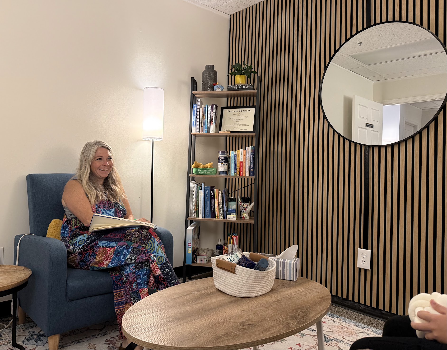 A therapist in conversation with a young client in a calm office